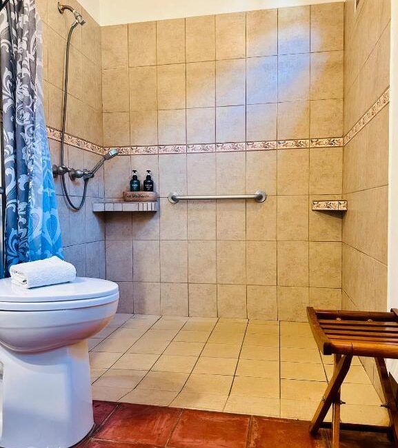 Hotel bathroom with toilet and shower stall.